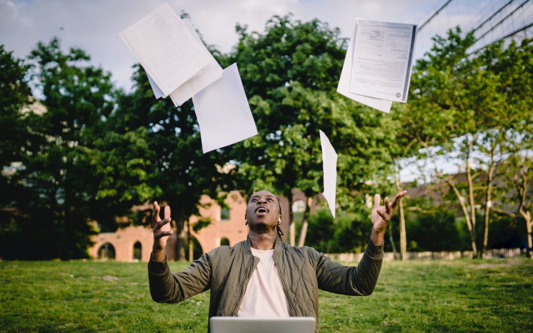A happy student tosses his homework in the air